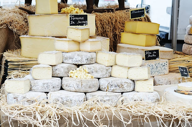 French cheeses on market stall stock photo