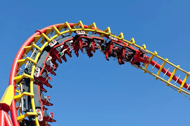 rollercoaster against blue sky, entertainment in amusement park