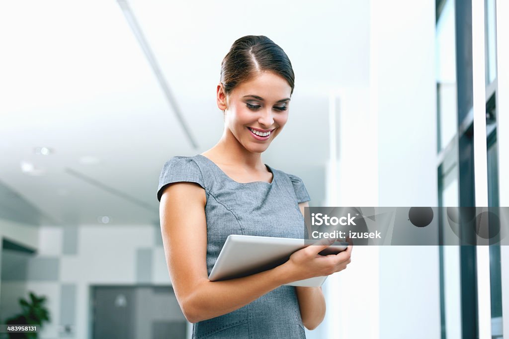 Businesswoman with digital tablet Portrait of an attractive businesswoman using a digital tablet. 25-29 Years Stock Photo