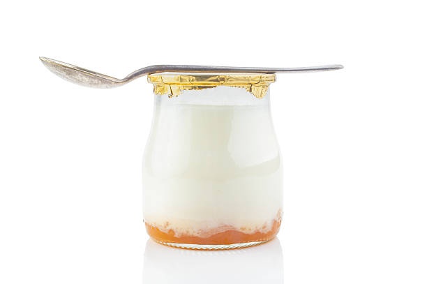 istock Greek yogurt with in a glass jars with spoon 483958179