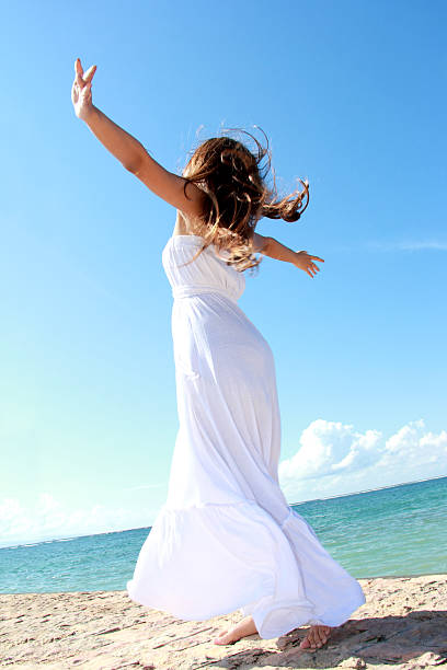 istock Woman relaxing at the beach with arms open 483958287