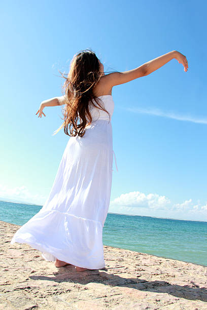 istock Woman relaxing at the beach with arms open 483958289