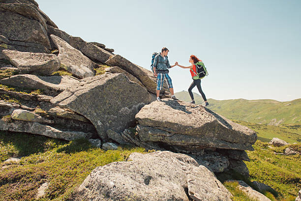 istock Young couple climbing in the mountains 483959050
