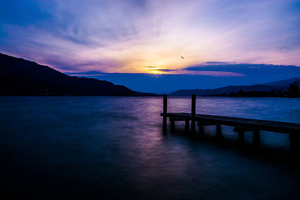 my promised land longtime exposure of a lake (Wörthersee, Austria) during sunset. pörtschach am wörthersee stock pictures, royalty-free photos & images
