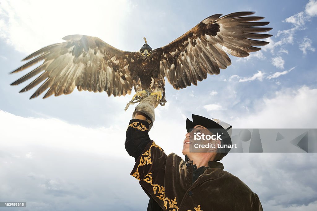 Traditional Kyrgyz Hunter Holding Eagle Hunting with golden eagles is a traditional art of the Eurasian steppes, particularly in Central Asia. Kazakhstan Stock Photo