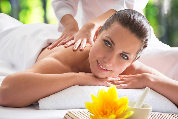 istock Young beautiful woman in spa environment 483960582