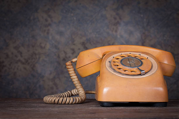 istock Old telephone on wood table. 483960625