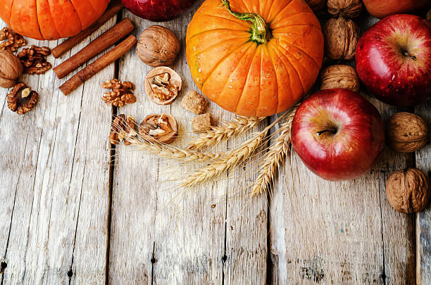 istock wood background with pumpkin, apples, wheat, honey and nuts 483960968