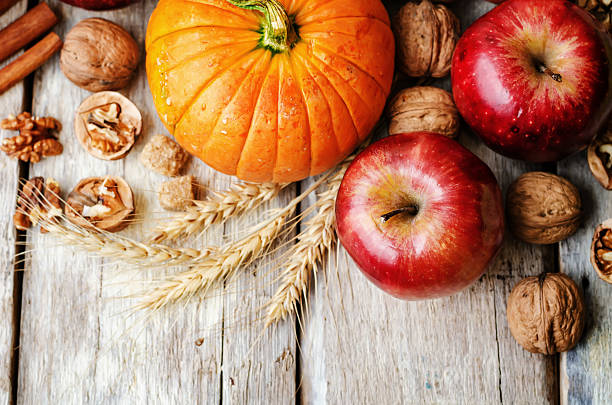 istock wood background with pumpkin, apples, wheat, honey and nuts 483960970