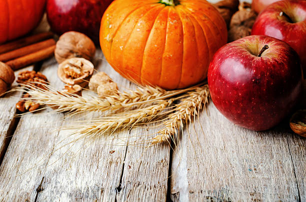 istock wood background with pumpkin, apples, wheat, honey and nuts 483960974