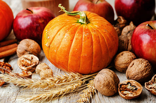 istock wood background with pumpkin, apples, wheat, honey and nuts 483960982