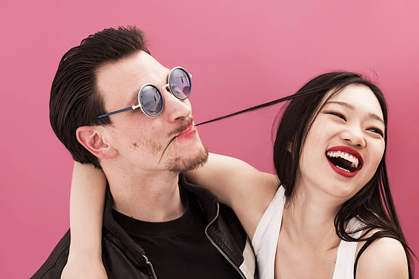 istock Funny man wearing lipstick and his laughing girlfriend 483963402