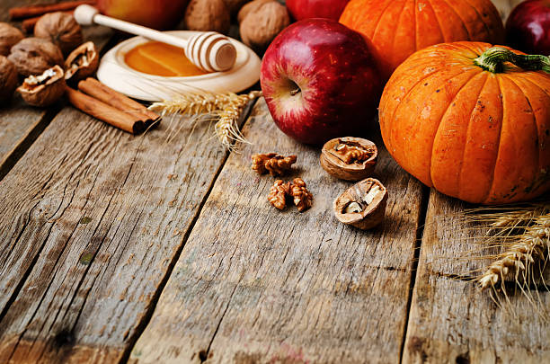 istock wood background with pumpkin, apples, wheat, honey and nuts 483967278