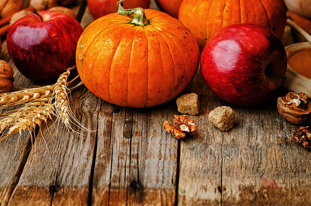 istock wood background with pumpkin, apples, wheat, honey and nuts 483967318
