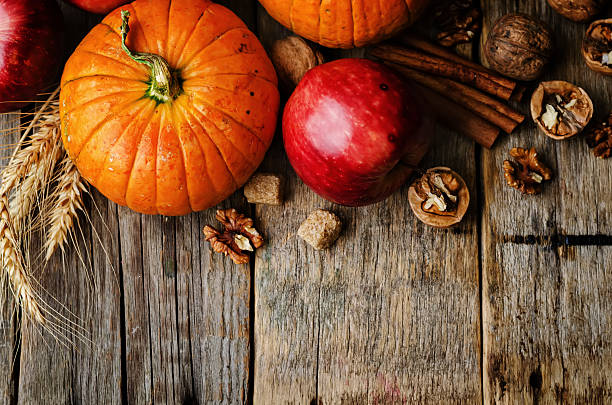 istock wood background with pumpkin, apples, wheat, honey and nuts 483967342