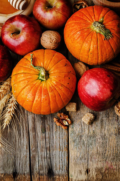 istock wood background with pumpkin, apples, wheat, honey and nuts 483967344