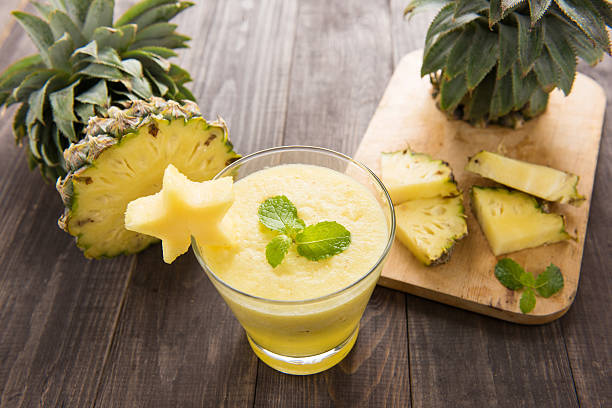 istock Pineapple smoothie with fresh pineapple on wooden table 483974872