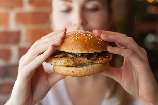 istock Woman eating some burger 483978916