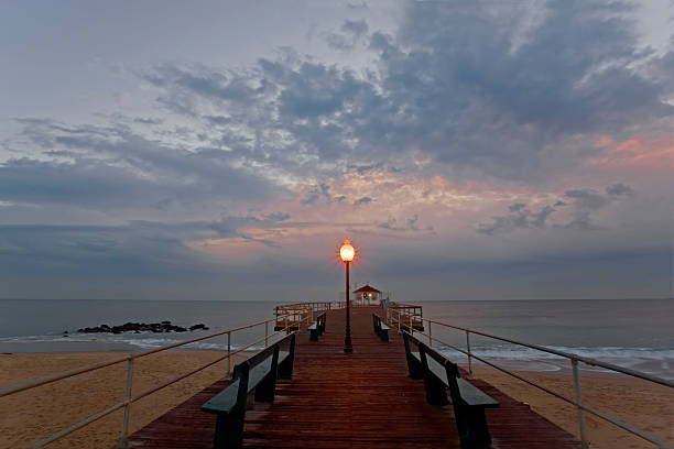 istock Quiet twilight view of a ocean shore and pier 483984164