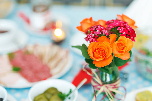 Flower arrangement on the diner table. Very soft focus.