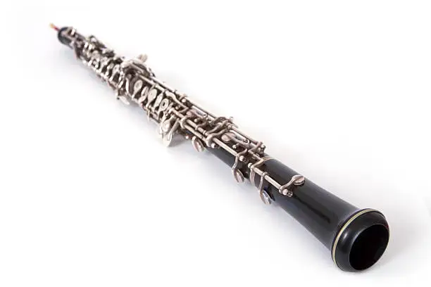 This is an oboe, the woodwind that sits next to the flutes in an orchestra. Use this image with confidence; I am an oboe player, and this is indeed an oboe. Many people see a long black woodwind and think "clarinet". Or they hear the word oboe, and think "that big long instrument that looks like a bedpost" (no, that's a bassoon). Anyway, this is the genuine article, the instrument that plays the duck in Peter and the Wolf. Isolated on white.