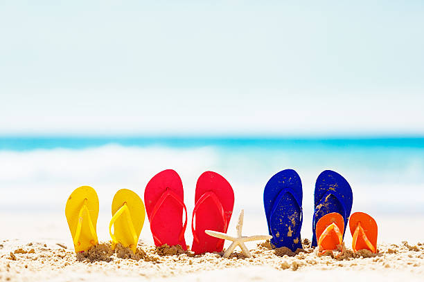 istock Family holiday fun! Flipflops on the beach. 483990023