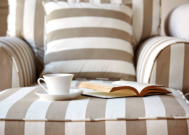 istock Living room sofa with coffee and book close up 483990037