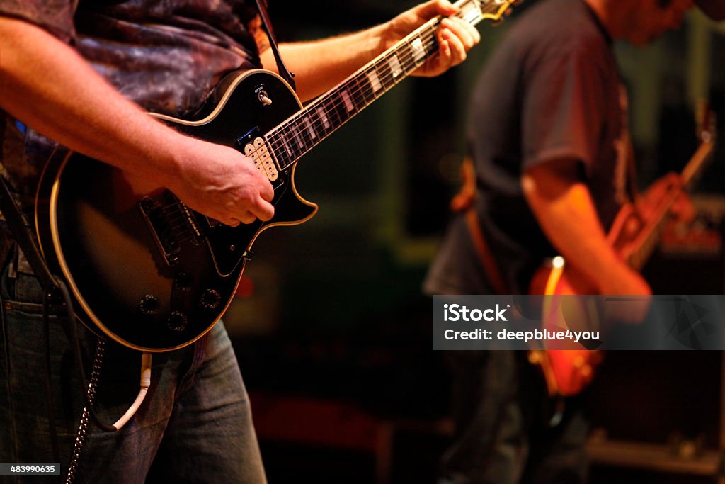 Guitarists at nightclub Two rock guitarists playing guitar at a live concert. Restaurant Stock Photo
