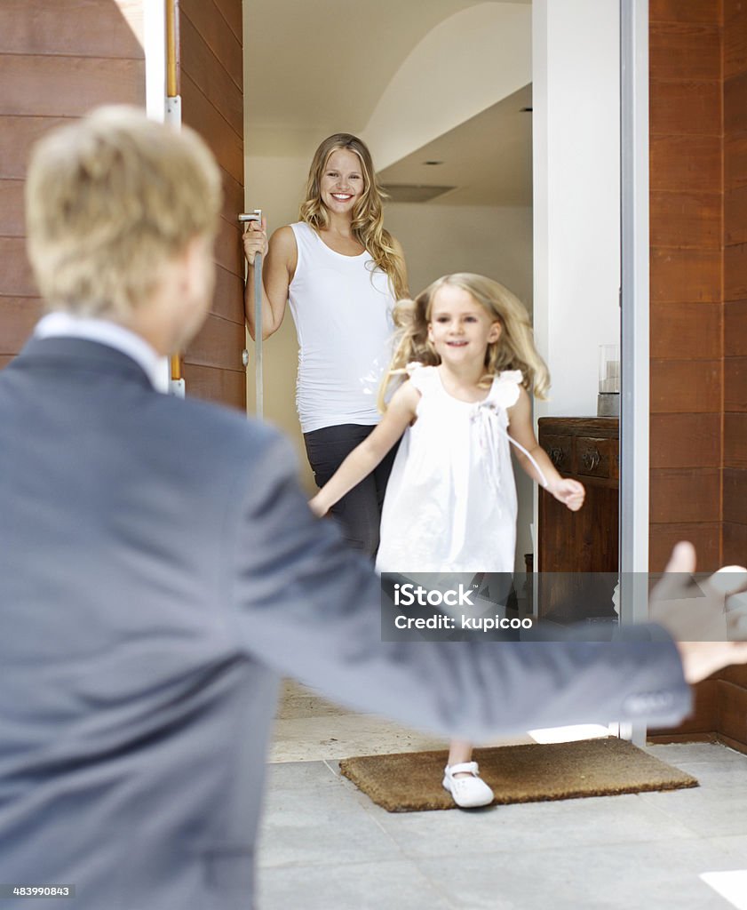 She's always been daddy's girl! Cute little girl running towards her father as he arrives home from work 30-39 Years Stock Photo