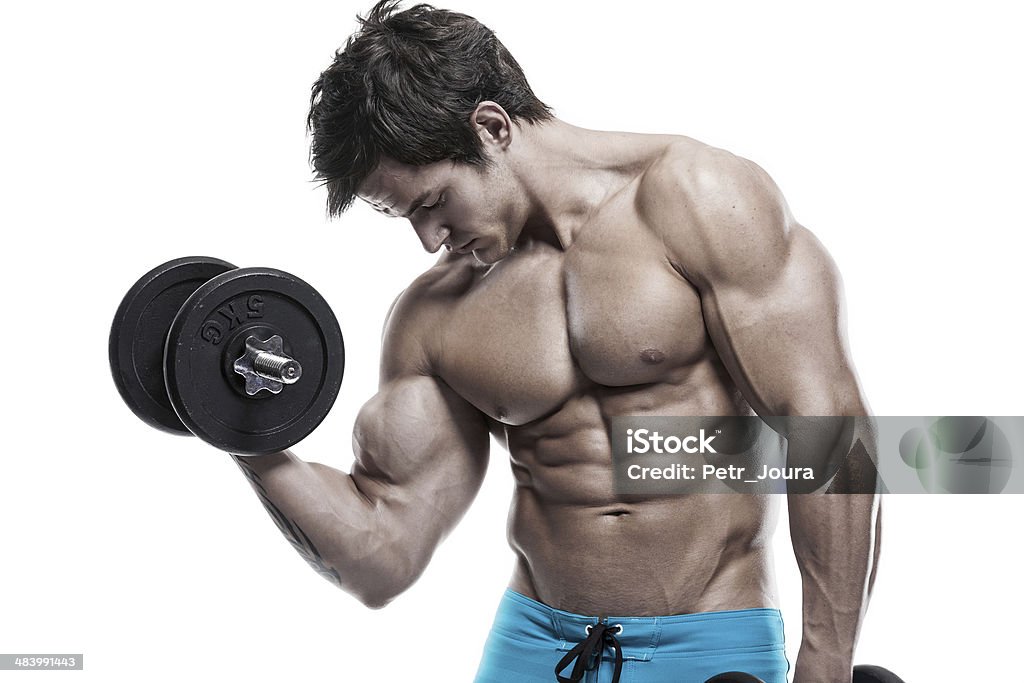 Muscular bodybuilder guy doing exercises with dumbbells Muscular bodybuilder guy doing exercises with dumbbells isolated over white background Abdominal Muscle Stock Photo
