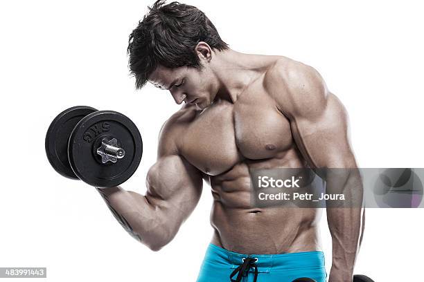 Muscular Bodybuilder Guy Doing Exercises With Dumbbells Stock Photo - Download Image Now