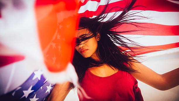 istock Woman with american flag, eyes closed 483992031