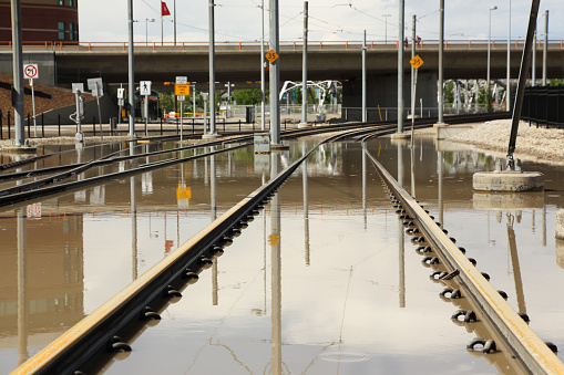 Calgary, Canada - June 22, 2013: Even as flood waters recede, flooded Calgary Transit train tracks remain a stark reminder of some of the worst flooding in Calgary's history.