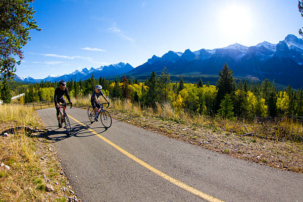 Father and Son Road Bicycling A father and son ride road bicycles on the Legacy Trail in Banff National Park, Alberta, Canada. canadian rockies stock pictures, royalty-free photos & images