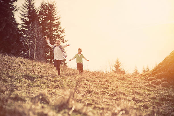 istock Happy kids running through a mountain meadow. 483993433