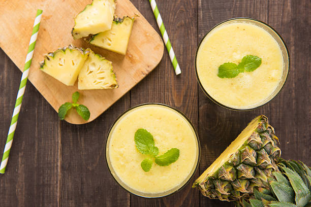istock Pineapple smoothie with fresh pineapple on wooden table 483993530
