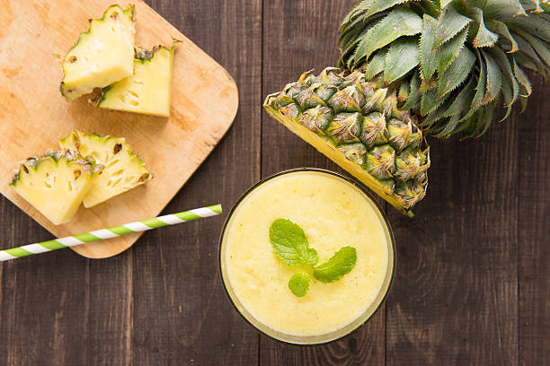 istock Pineapple smoothie with fresh pineapple on wooden table 483993538