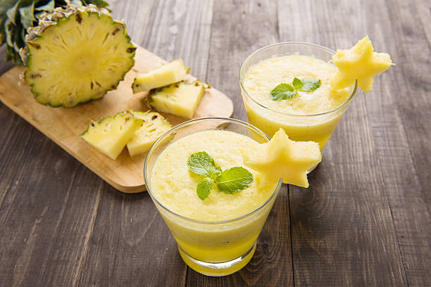 istock Pineapple smoothie with fresh pineapple on wooden table 483993544