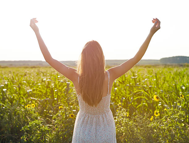 istock Woman enjoying sunset in the open field 483993606