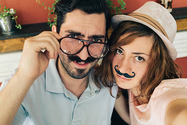 istock Couple making selfie with mustaches 483994328