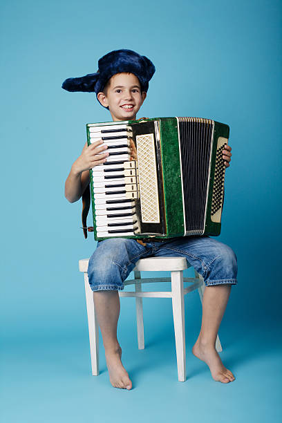 istock little accordion player on blue background 483994658