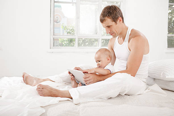 istock Young father and his nine months old son with digital 483997874