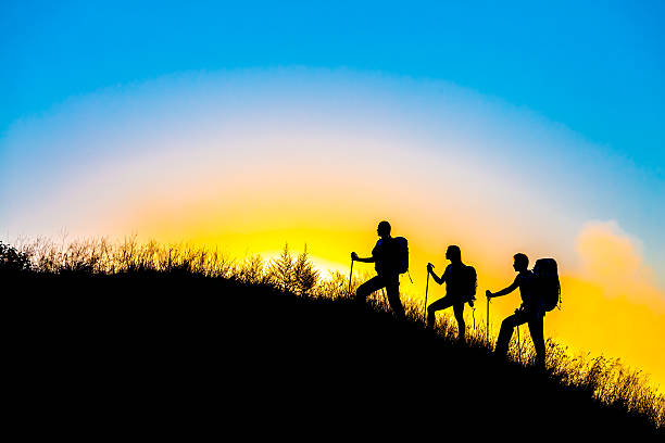 istock Three people family silhouettes on vacation 483998262