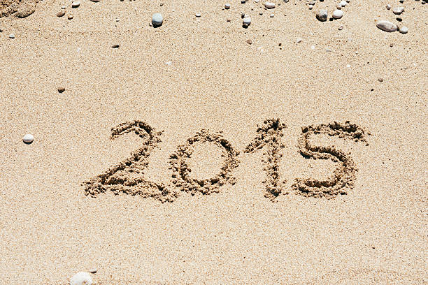 Year 2015 marked on the sandy beach in summertime