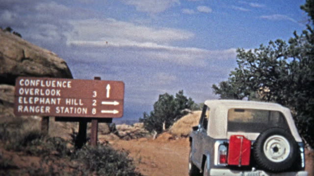 CANYONLANDS, UTAH -1971: Jeep offroad driving to the Confluence Canyon Overlook.