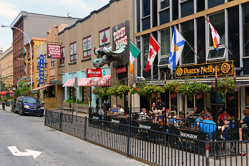Halifax, Canada - August 3, 2015:  People enjoy a patio on a summer afternoon on Argyle Street which contains several bars and restaurants in the city which is known for its night life.