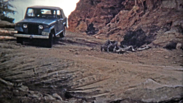 CANYONLANDS, UTAH -1971: Jeep driving down the famous silver stairs offroad trail and geological rock formation.