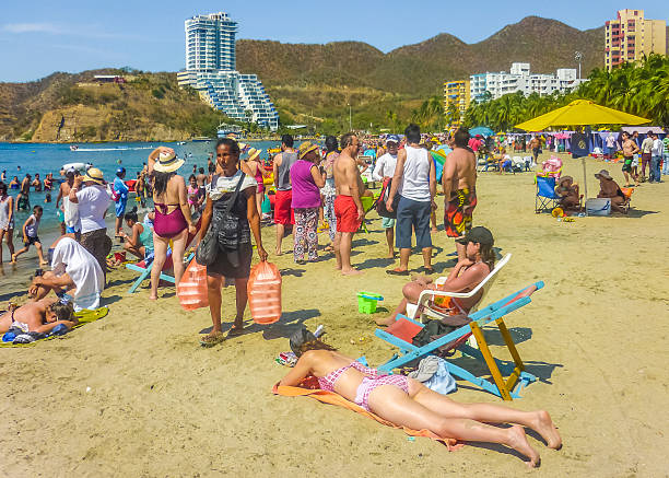 Santa Marta, Colombia, January 5,  2015 : Sunny day at crowded beach at El Rodadero, one of the most famous and visited watering places of Colombia.