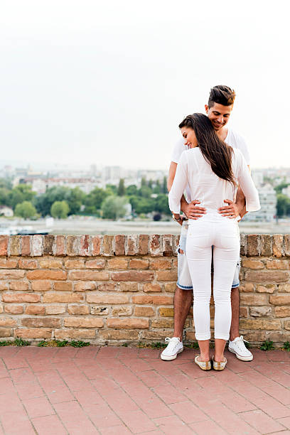 istock Young couple holding each other around waist 484010716
