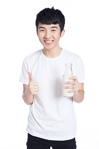 Portrait of asian man holding a cup of  milk isolated on white background
